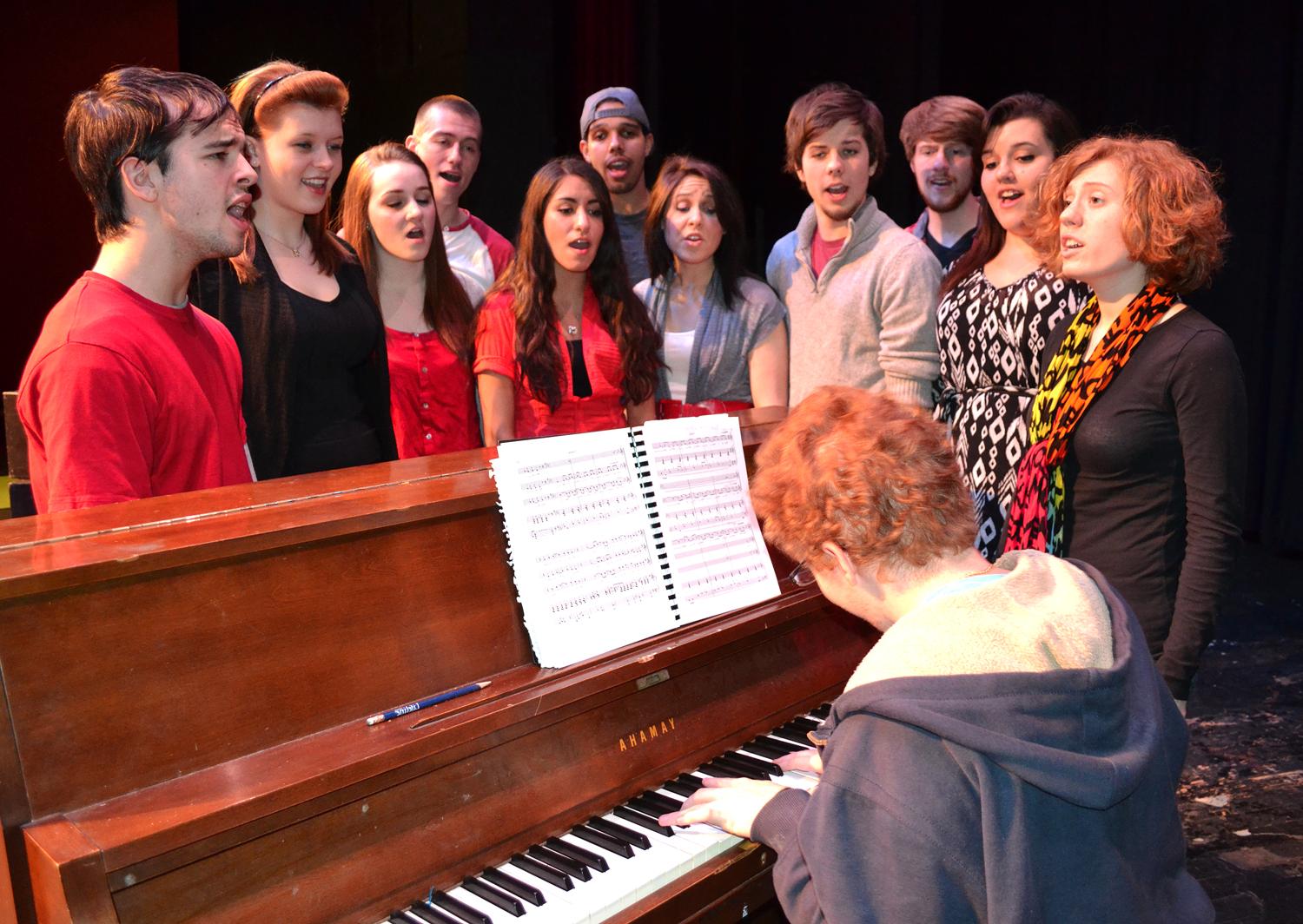 Cast singing by piano 